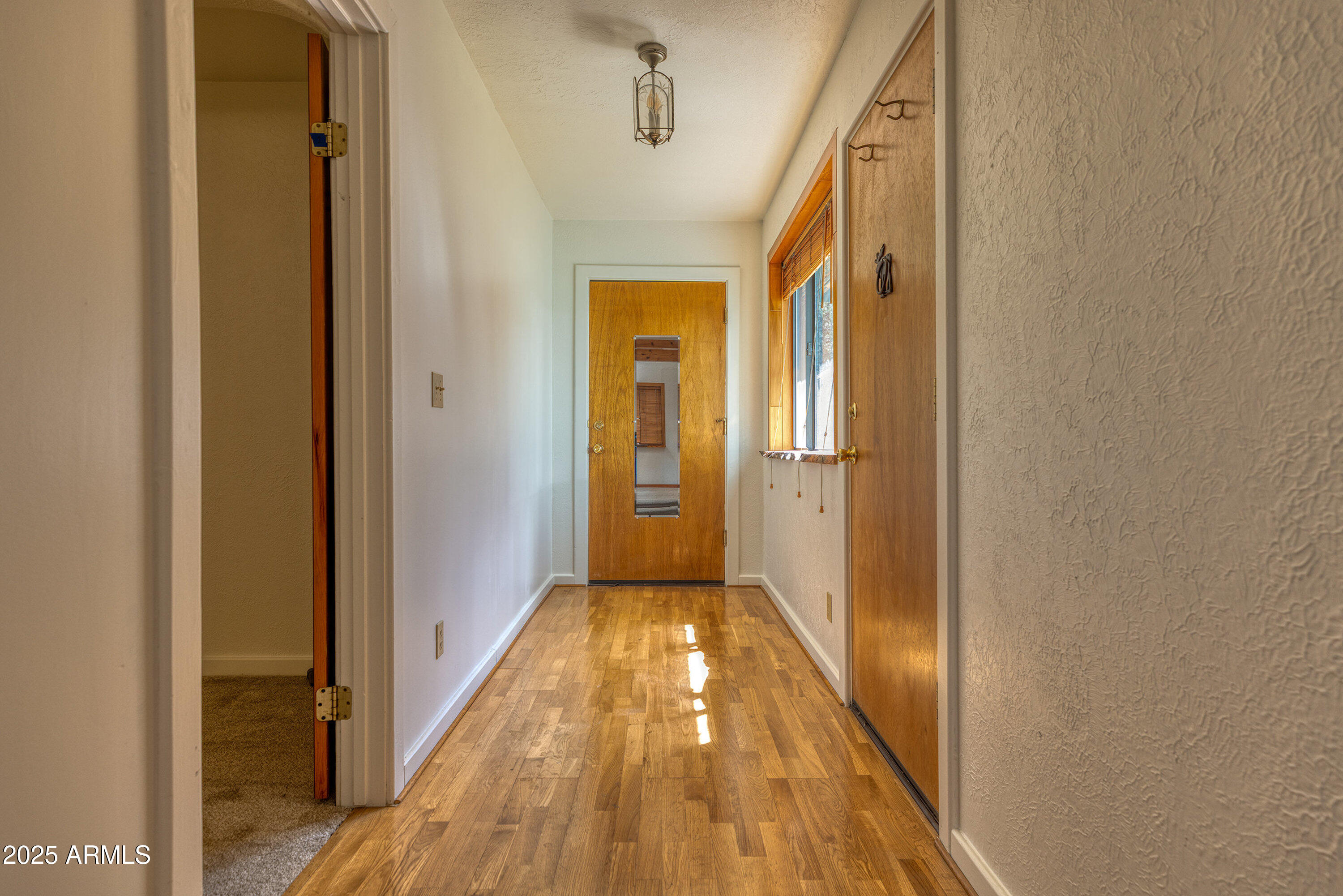 5382 Pine Dawn Road Lakeside, AZ 85929 - Photo 20 of 38 a view of a hallway with wooden floor and staircase