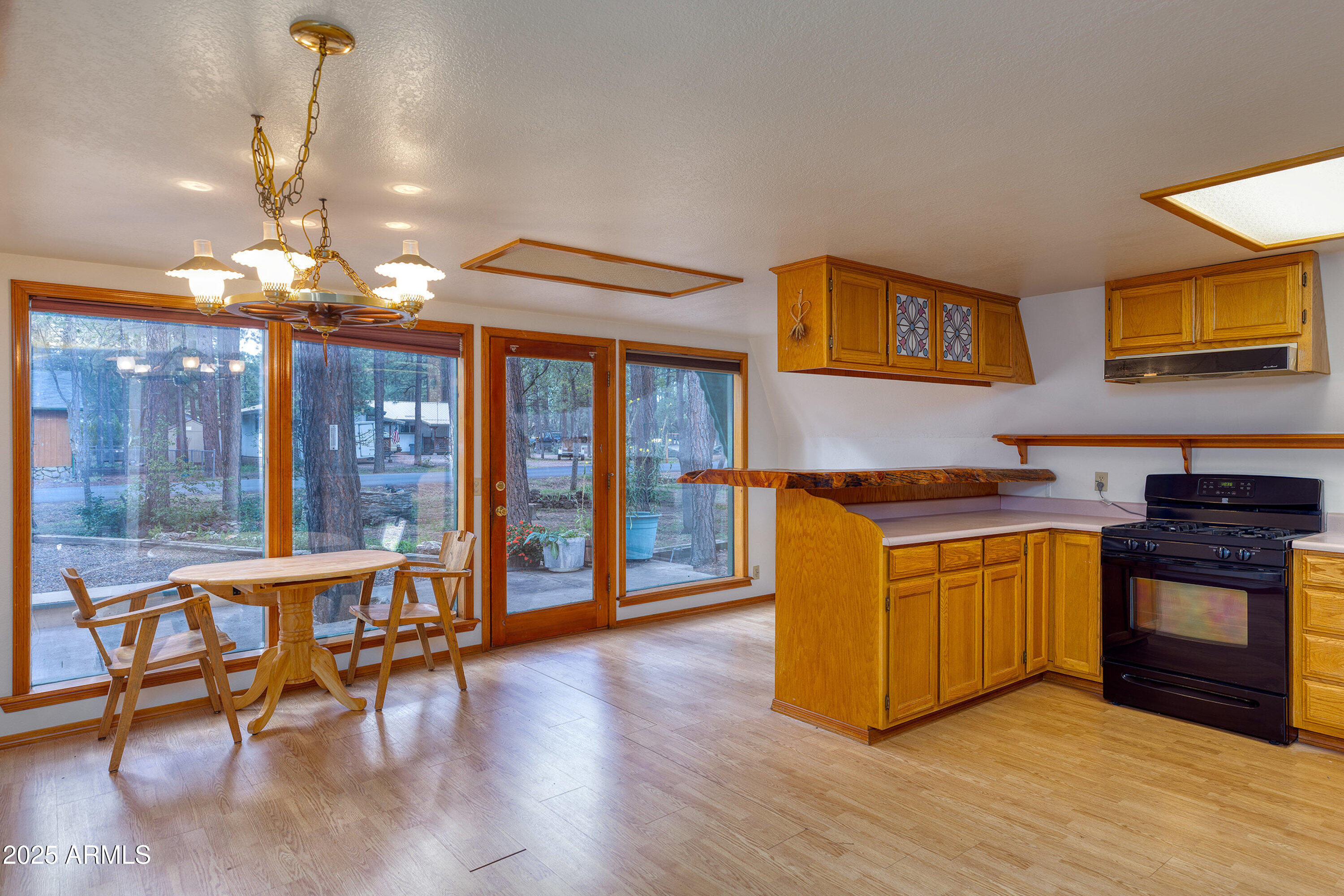 5382 Pine Dawn Road Lakeside, AZ 85929 - Photo 10 of 38 a kitchen with stainless steel appliances granite countertop a stove and a wooden floors