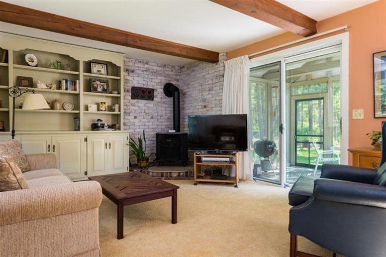 110 Olde Knoll Road Marion, MA 02738 - Photo 12 of 12 a living room with furniture a flat screen tv and a fireplace