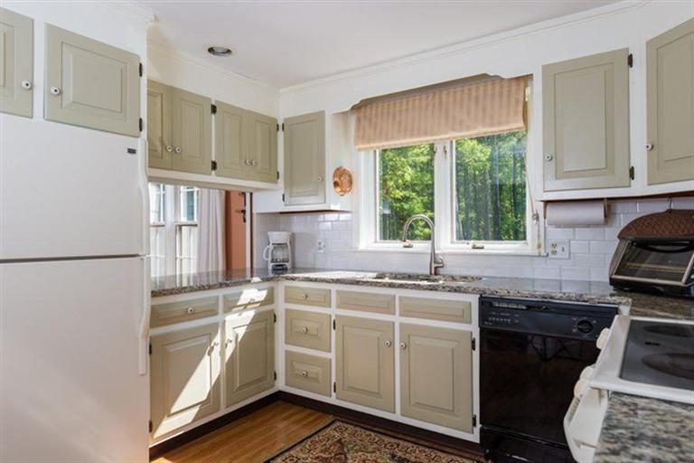 110 Olde Knoll Road Marion, MA 02738 - Photo 8 of 12 a kitchen with a sink stove and cabinets