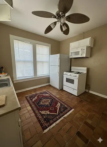 a living room with a rug and a stove