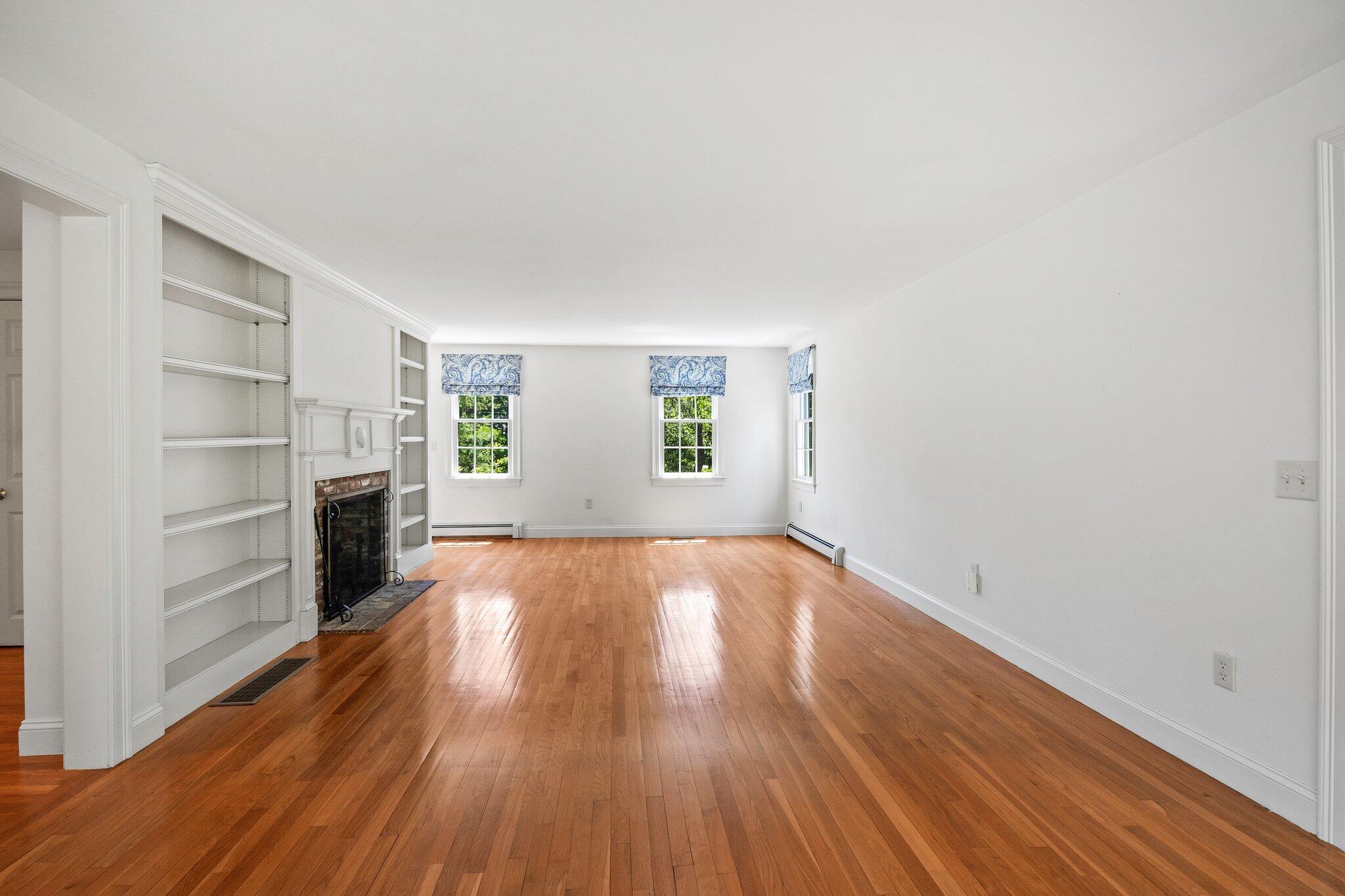 75 Whidah Road Chatham, MA 02650 - Photo 12 of 47 a view of empty room with a fireplace and wooden floor