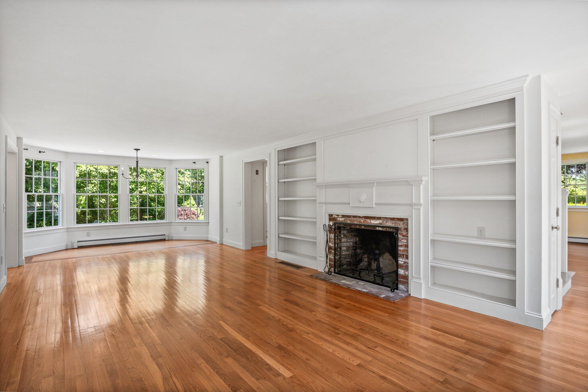75 Whidah Road Chatham, MA 02650 - Photo 9 of 47 a view of an empty room with wooden floor fireplace and a window