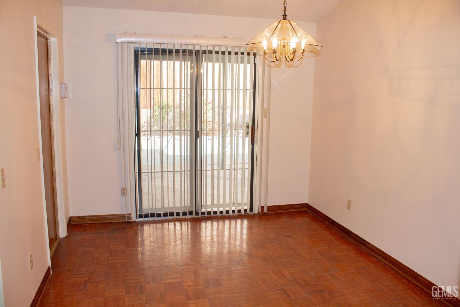 Undisclosed Address Bakersfield, CA 93306 - Photo 11 of 29 a view of an empty room with window and wooden floor