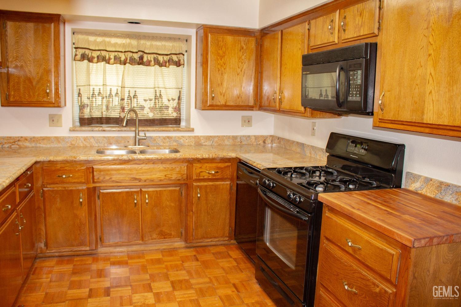 Undisclosed Address Bakersfield, CA 93306 - Photo 12 of 29 a kitchen with stainless steel appliances granite countertop a stove a sink and a microwave