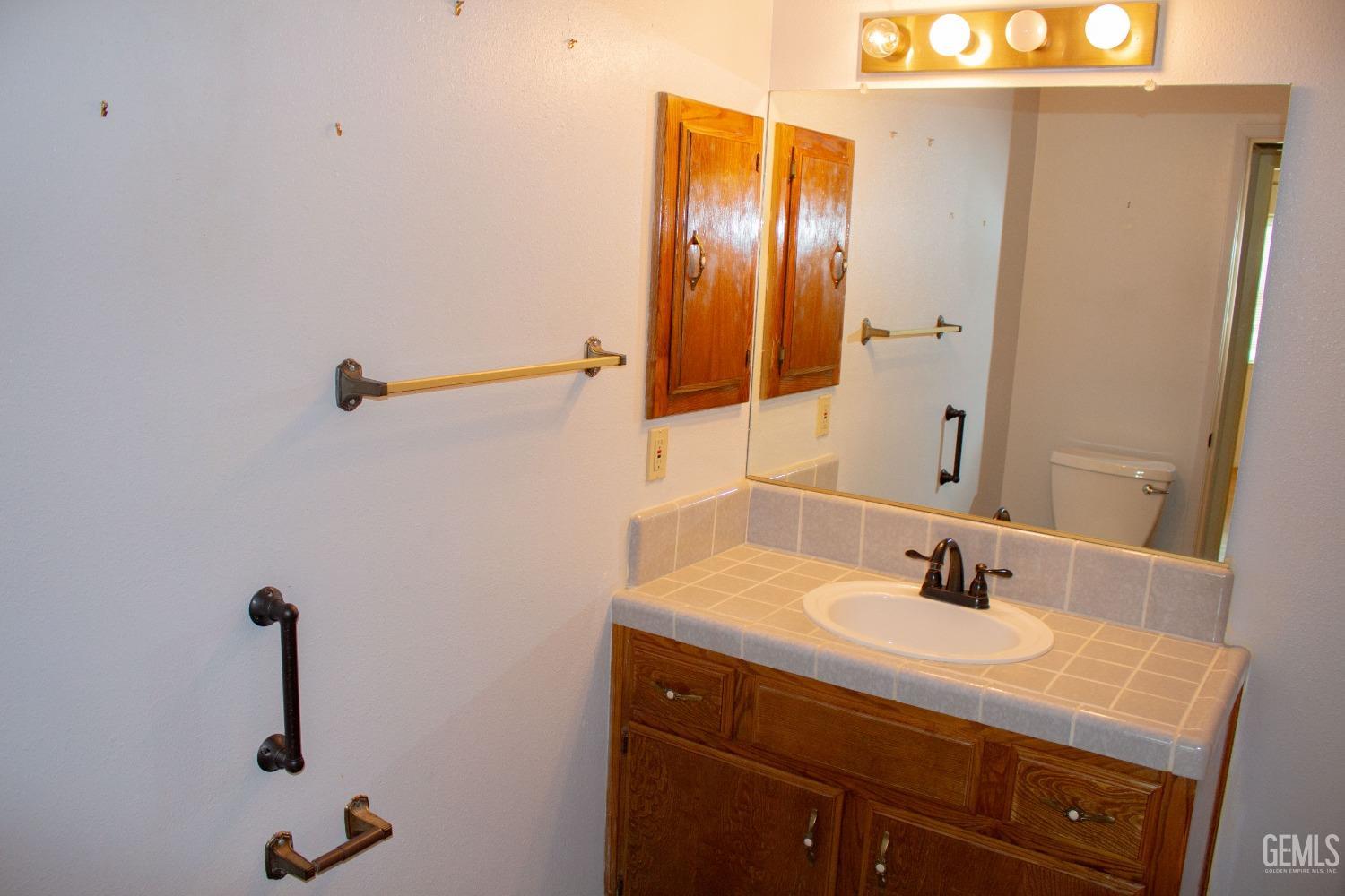 Undisclosed Address Bakersfield, CA 93306 - Photo 16 of 29 a bathroom with a sink and mirror