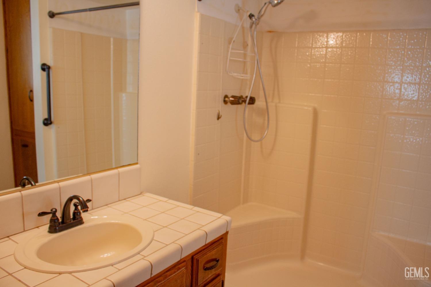 Undisclosed Address Bakersfield, CA 93306 - Photo 21 of 29 a bathroom with a sink and a mirror