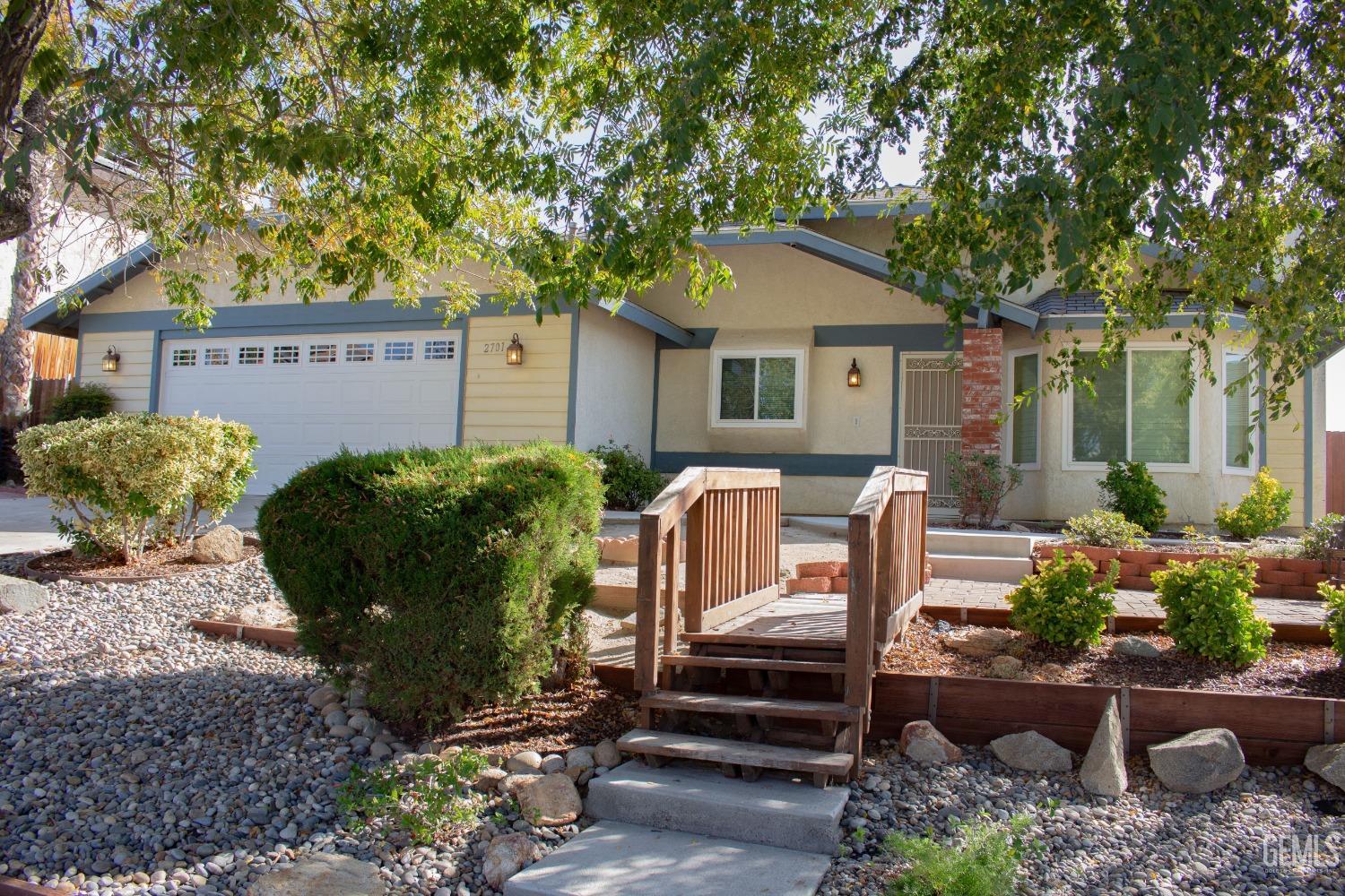 Undisclosed Address Bakersfield, CA 93306 - Photo 3 of 29 a view of a house with a yard and a garden