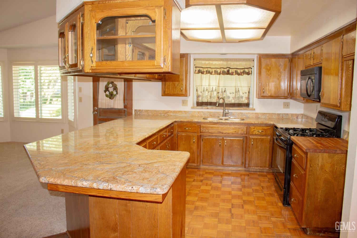 Undisclosed Address Bakersfield, CA 93306 - Photo 8 of 29 a kitchen with stainless steel appliances granite countertop a sink stove and cabinets