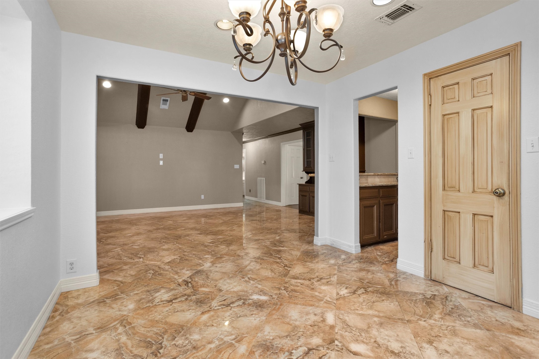 6903 Farnaby Court Spring, TX 77379 - Photo 13 of 49 a view of a hallway with chandelier