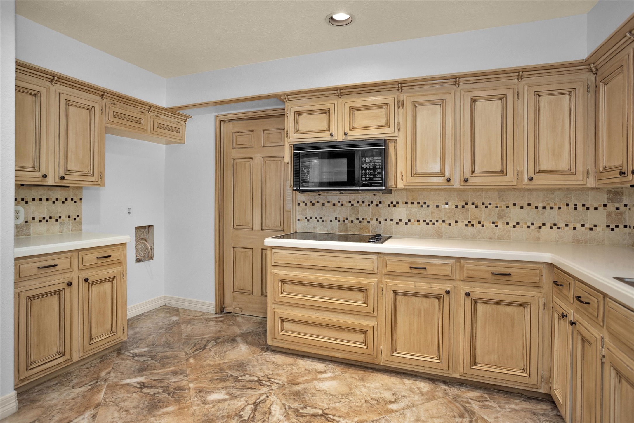 6903 Farnaby Court Spring, TX 77379 - Photo 16 of 49 a kitchen with granite countertop a sink and a stove top oven