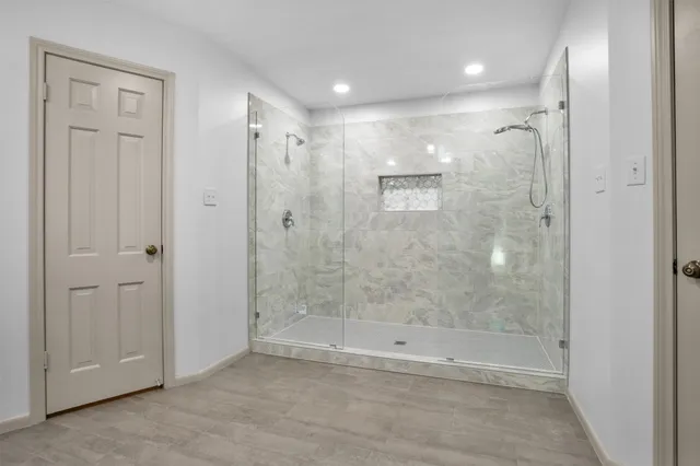 a bathroom with a shower and a glass door