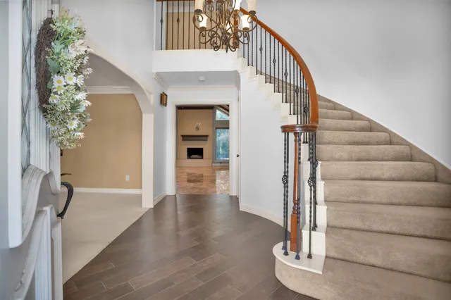 a view of entryway and hall with wooden floor