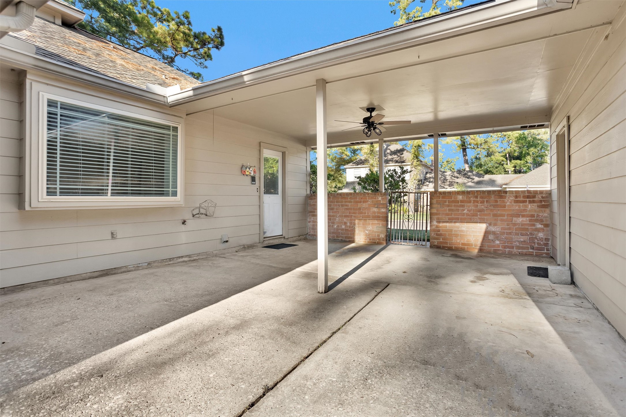 6903 Farnaby Court Spring, TX 77379 - Photo 44 of 49 a view of a porch with a table and chairs and floor to ceiling window