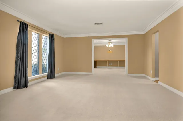 a view of a livingroom with a staircase and a kitchen
