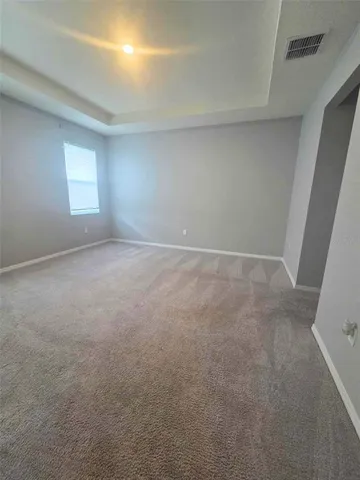 a view of an empty room and a window