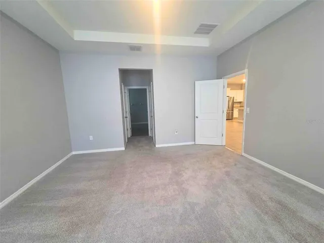 a view of an empty room and a window
