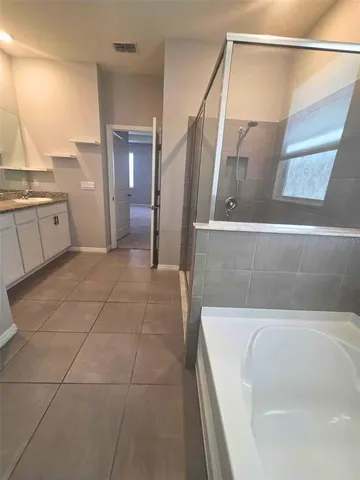 a bathroom with a bathtub and shower