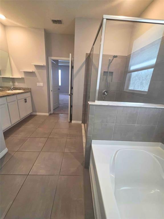 3927 Lively Coral Place Bradenton, FL 34208 - Photo 25 of 44 a bathroom with a bathtub and shower