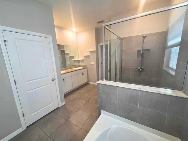 a bathroom with a shower and a tub