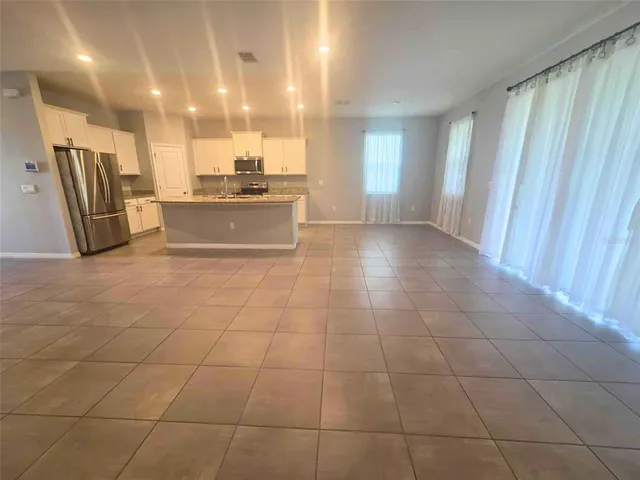 a view of a kitchen with a sink and cabinets
