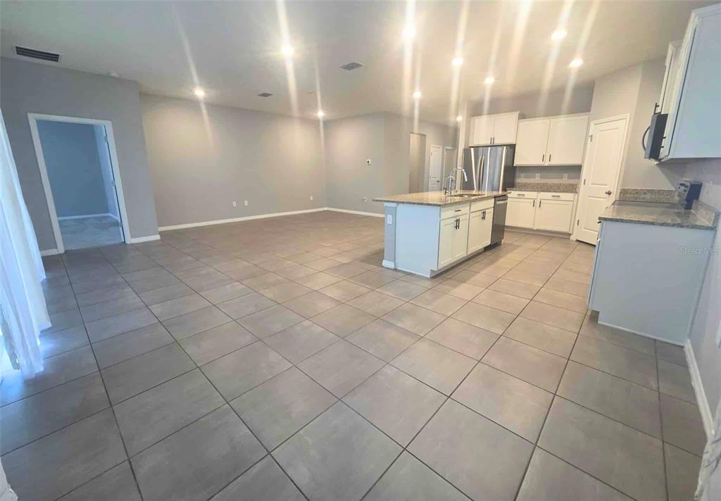3927 Lively Coral Place Bradenton, FL 34208 - Photo 8 of 44 a kitchen with stainless steel appliances granite countertop a sink and a stove top oven