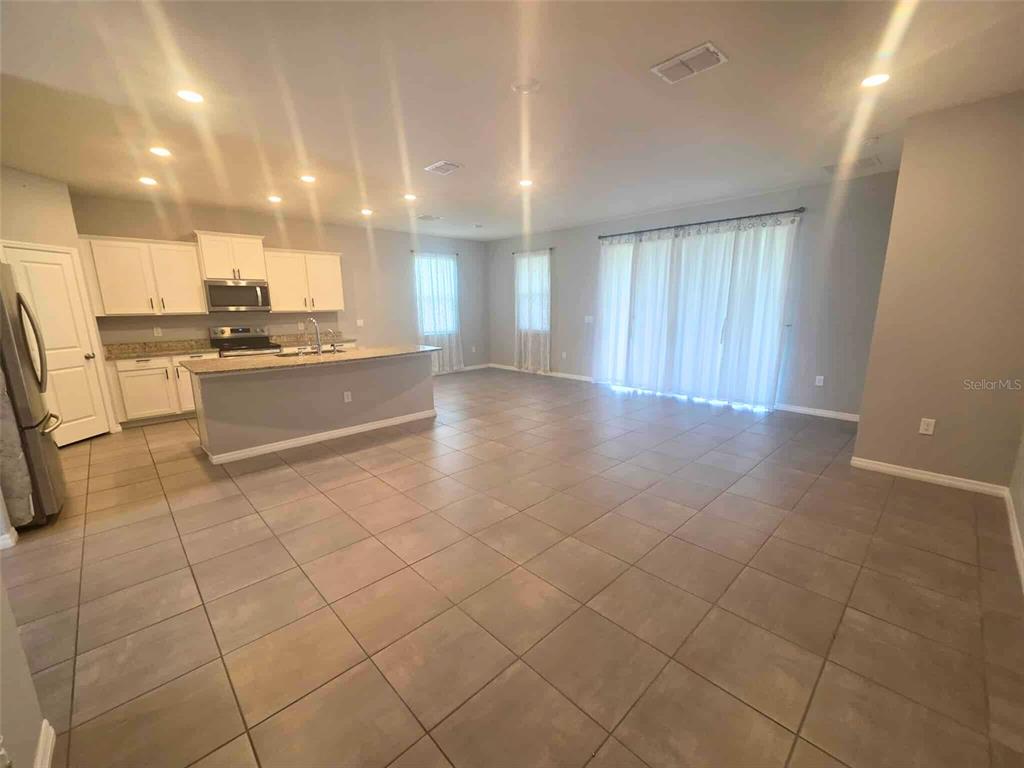 3927 Lively Coral Place Bradenton, FL 34208 - Photo 10 of 44 a large white kitchen with a sink and cabinets