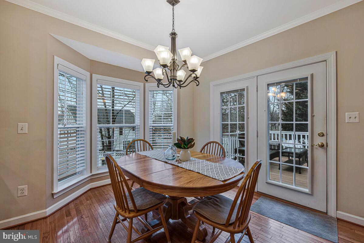 620 Crawfords Ridge Road Odenton, MD 21113 - Photo 11 of 43 a dining room with furniture a chandelier and wooden floor