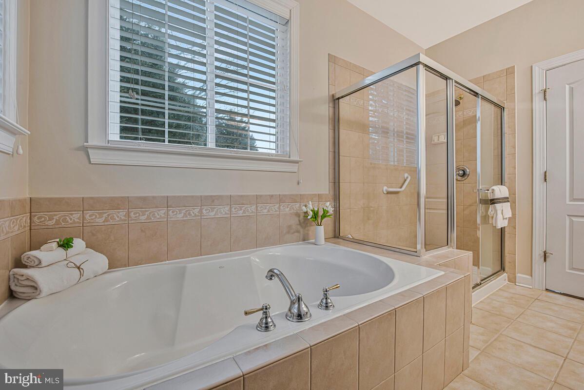 620 Crawfords Ridge Road Odenton, MD 21113 - Photo 23 of 43 a bathroom with a tub and a shower
