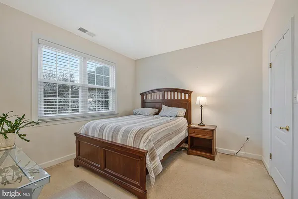 a bedroom with a bed and a potted plant