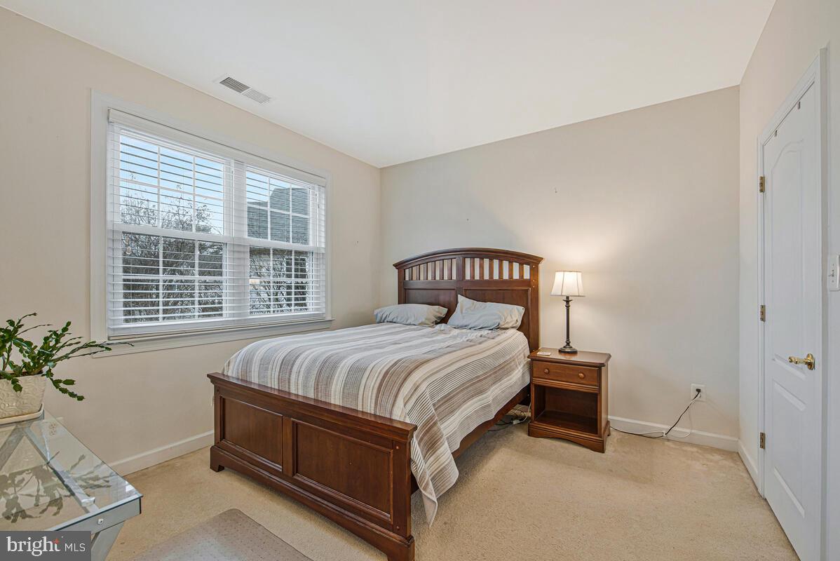 620 Crawfords Ridge Road Odenton, MD 21113 - Photo 27 of 43 a bedroom with a bed and a potted plant