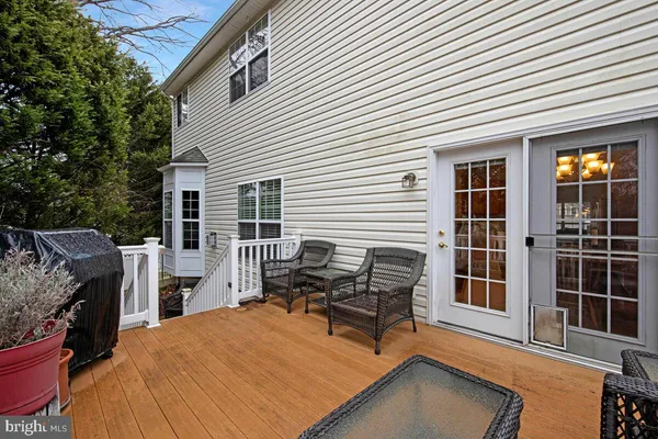 a backyard of a house with barbeque oven and outdoor seating