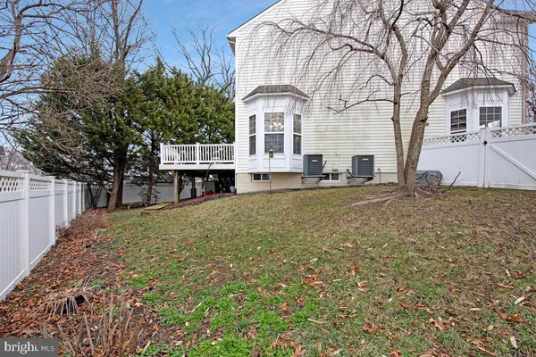 a large white building with a large tree in front of it