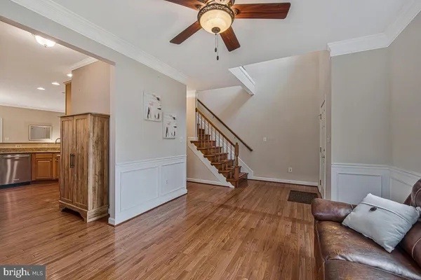 a view of hallway with furniture and wooden floor