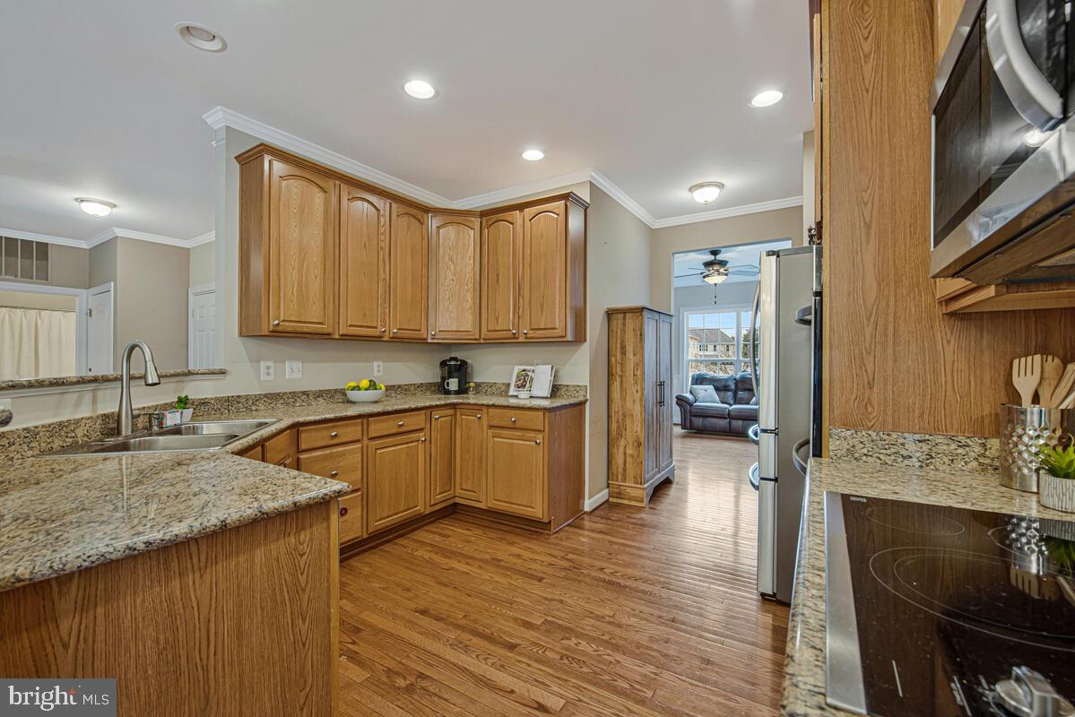 620 Crawfords Ridge Road Odenton, MD 21113 - Photo 7 of 43 a kitchen with stainless steel appliances granite countertop a sink stove and refrigerator