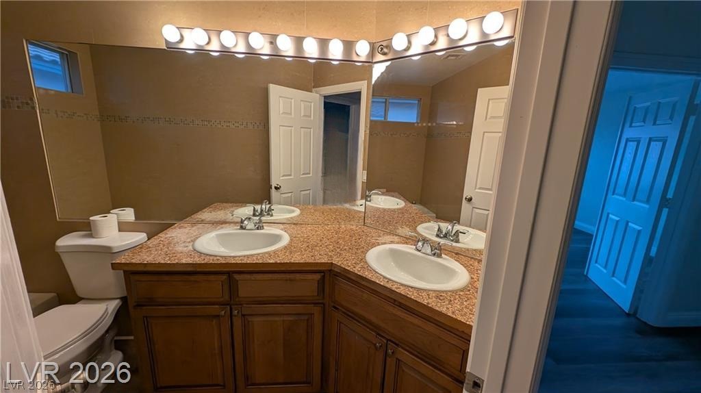 2670 Ridgewater Circle Henderson, NV 89074 - Photo 19 of 22 This functional bathroom features dual sinks with ample counter space and a built-in mirror.