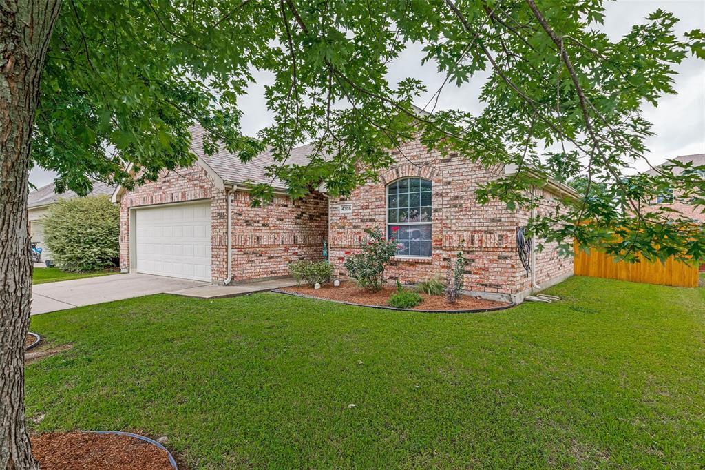 4305 Ridgewood Road Melissa, TX 75454 - Photo 2 of 26 Brick exterior with an arched window, attached garage, and concrete driveway