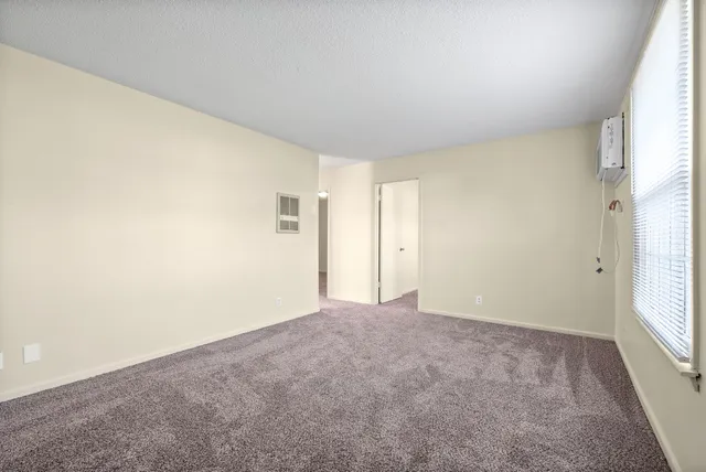 a view of an empty room and a window