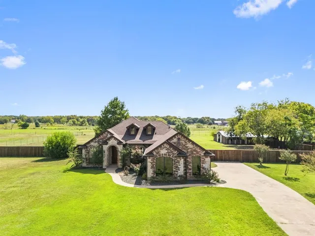 a view of a house with a yard and swimming pool