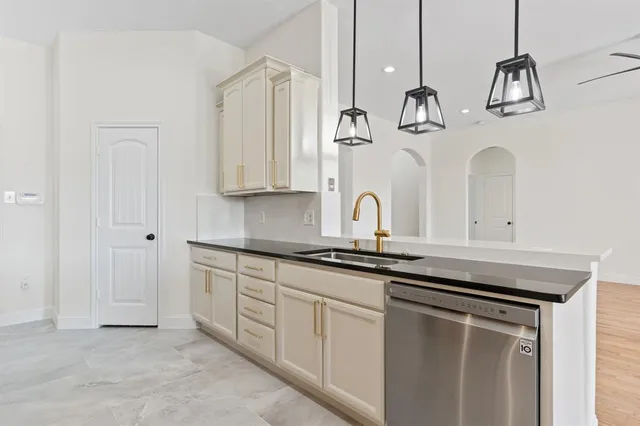 a kitchen with stainless steel appliances granite countertop a sink a stove and a microwave