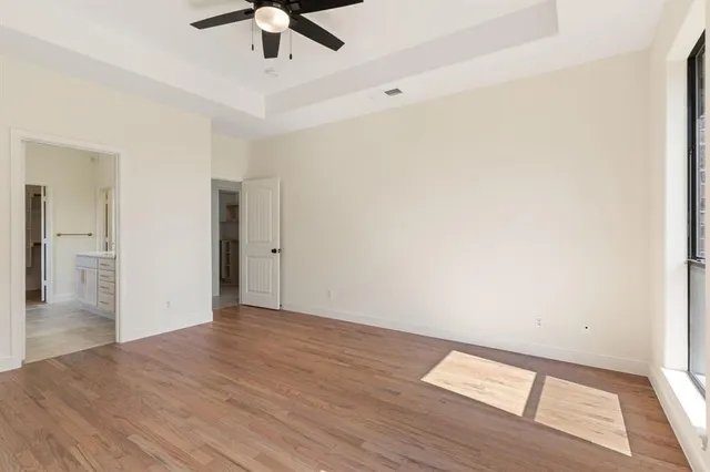 a view of empty room with wooden floor