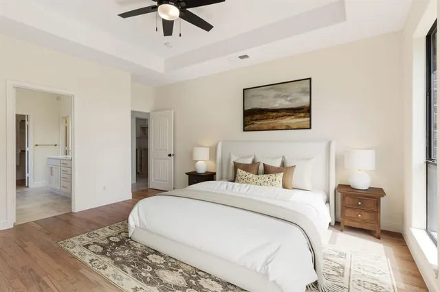 a bedroom with a large bed and a chandelier