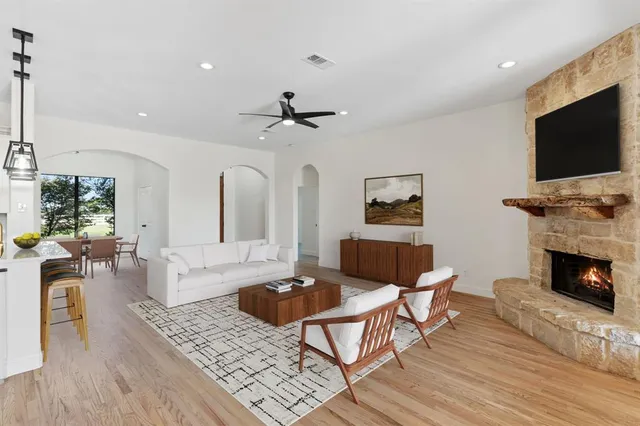 a living room with furniture a flat screen tv and a fireplace