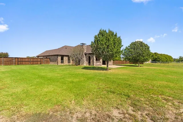 a view of a house with a yard and garage