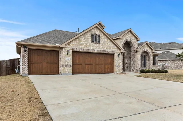 a front view of a house with a garage and a yard