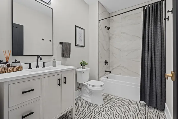 a bathroom with a sink toilet a shower and a mirror