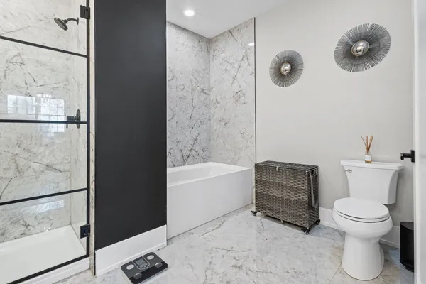 a bathroom with a toilet and a shower