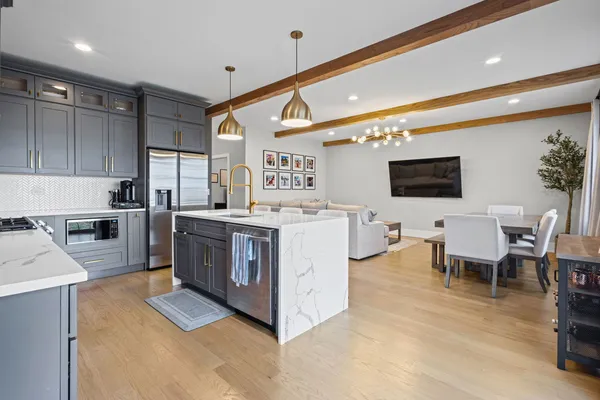 a kitchen with a sink stainless steel appliances and white cabinets