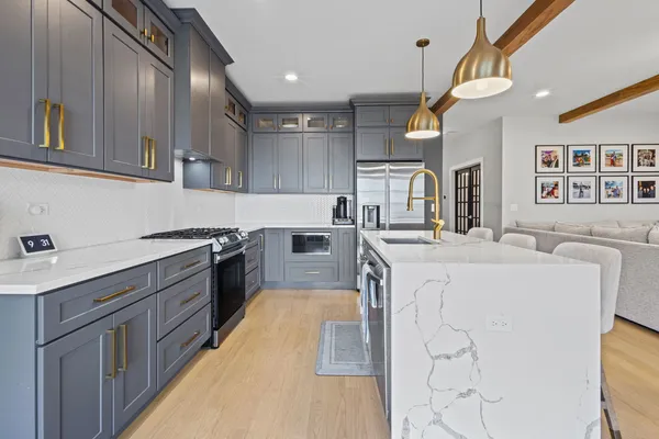 a large kitchen with stainless steel appliances lots of counter top space