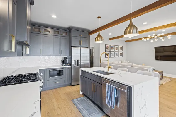 a kitchen with a sink stove and microwave